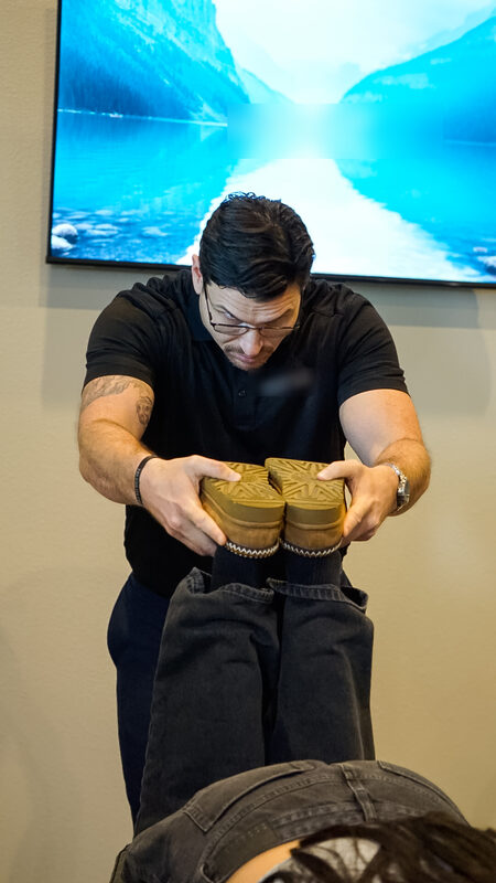 Dr. Ron Martin working on a patient's feet during a neuropathy session
